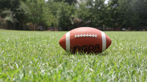 A football in a grassy field.
