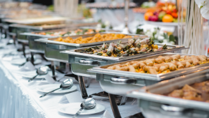 Wedding buffet with silver chafing dishes.