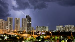 Lightening storm over a city at night.