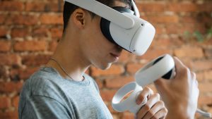 Young man wears a white VR headset.