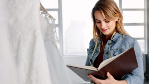 Wedding planner looking at her planning note book.
